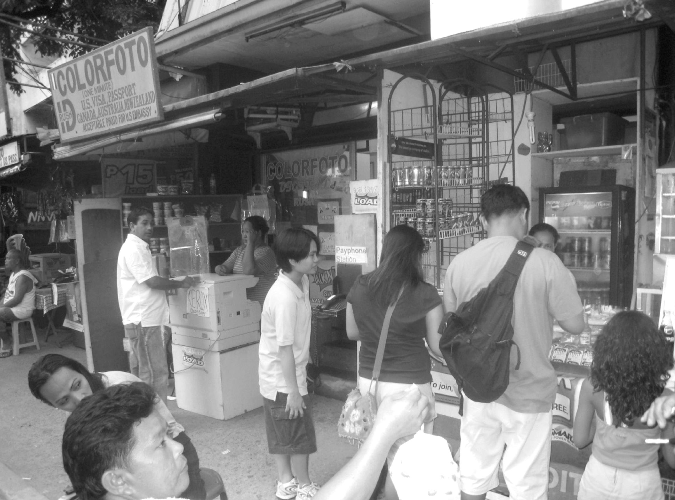 A '5-6 Bumbay' Lending Money to the Color Foto Lady Shop Owner