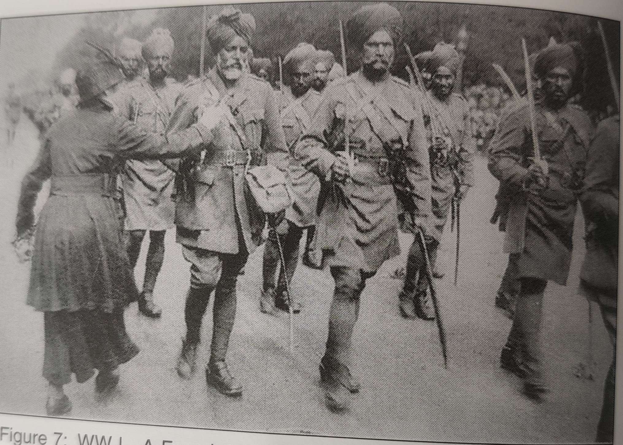 WWI- A French lady presenting flower to a Sikh Soldier taking part in a parade on Champs Elysees, Paris.